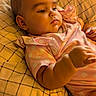 Ellyana is registered to the contest to win money with this photo: baby, infant, child, pink_clothing, polka_dot, pillow, plush_toy, indoor, portrait, cute, relaxed, sleepwear, soft_lighting, couch, person, head, hand, young_child, resting, home