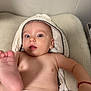 Thiago participe au concours pour gagner de l'argent avec cette photo : baby, infant, towel, diaper, foot, face, skin, arm, hand, expression, curious, soft_surface, hood, child, cute, lying_down, indoors, closeup, portrait, playful