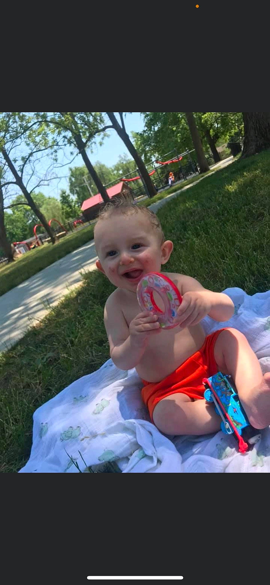 Broc joined the competition — help win amazing prizes! baby, baby_products, baby_toddler_clothing, child, event, fun, grass, happy, human_leg, lap, leisure, person, plant, recreation, shorts, sitting, sky, smile, thigh, toddler