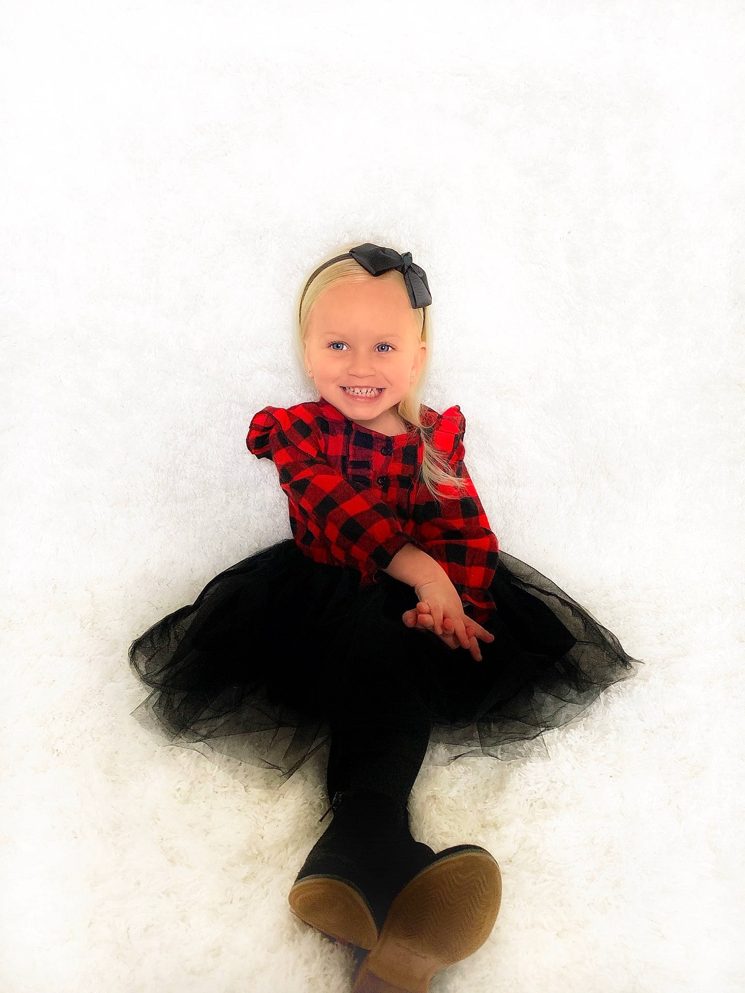 Brynn is registered to the contest to win money with this photo: baby, baby_toddler_clothing, child_model, collar, costume, costume_accessory, fur, headwear, joy, knee, lip, pattern, person, photo_shoot, plaid, shoe, sitting, sleeve, sock, style