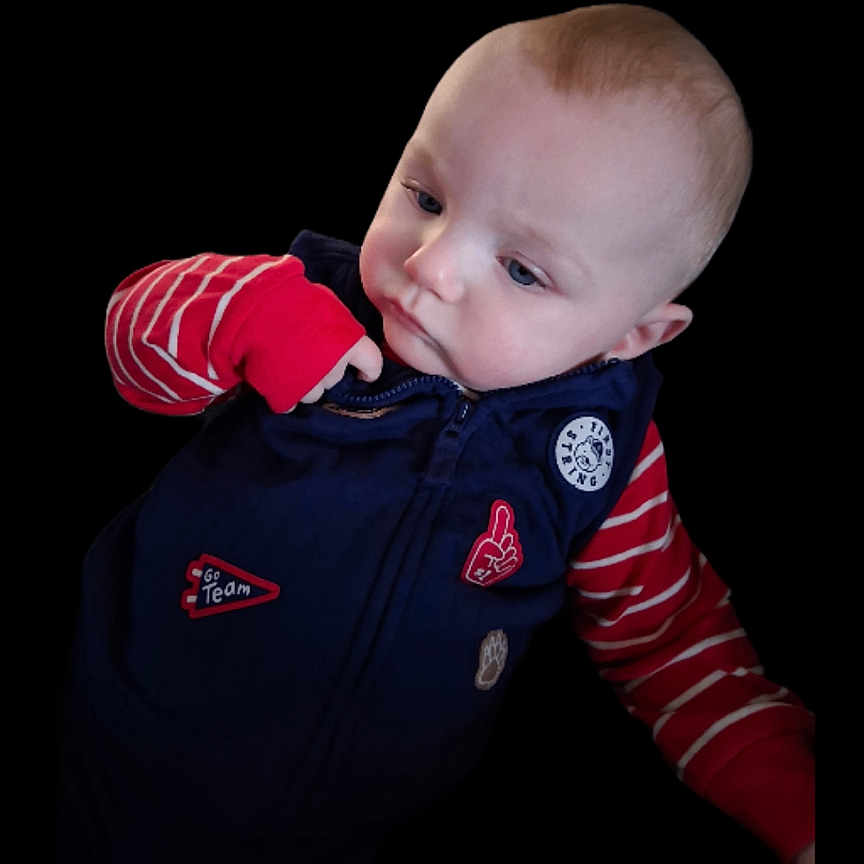 Cole joined the competition — help win amazing prizes! baby, black_background, blue_eyes, child, clothing, curious, cute, expression, face, fashion, head, indoor, infant, isolated, navy_vest, person, portrait, red_striped_sleeves, skin, young