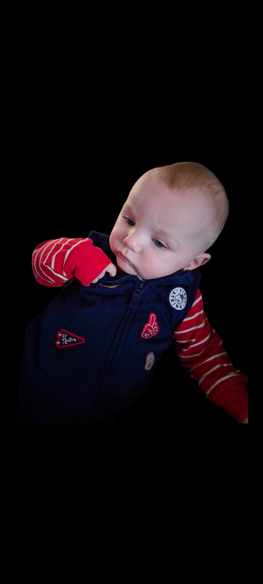 Cole joined the competition — help win amazing prizes! baby, child, infant, face, blue_eyes, red_striped_sleeves, navy_vest, curious, portrait, isolated, black_background, cute, young, clothing, fashion, indoor, expression, skin, head, person
