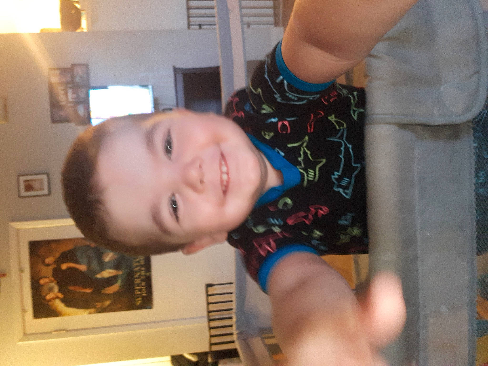 Dean is registered to the contest to win money with this photo: cheek, chest, child, ear, elbow, eyelash, finger, fun, gesture, happy, human_body, jaw, joy, mouth, nose, person, picture_frame, room, smile, thumb