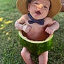 baby, watermelon, hat, bow_tie, outdoor, grass, happy, smiling, child, fruit, summer, cute, playful, nature, skin, barefoot, fun, green, headwear, portrait