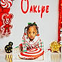 child, toddler, bed, pillow, holiday, christmas, decorations, gingerbread, candy, red, white, plaid, dress, hair_accessories, cute, indoor, portrait, festive, toy, holiday_theme