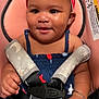 baby, child, car_seat, headband, bracelet, smile, face, clothing, straps, safety_buckle, arm, hand, skin, cute, infant, seat, indoors, happy, person, young_child
