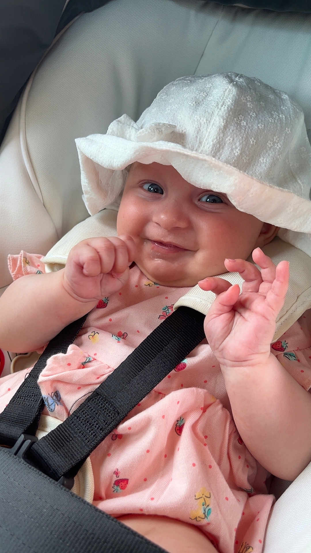 Adalynn is registered to the contest to win money with this photo: baby, child, hat, pink_dress, car_seat, smile, hands, straps, cute, infant, face, playful, seatbelt, clothing, closeup, portrait, happy, skin, headwear, sitting
