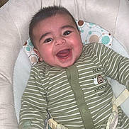 Liam participe au concours pour gagner de l'argent avec cette photo : baby, child, smiling, cute, onesie, striped_clothing, infant, cushion, baby_chair, happy, face, person, indoors, childcare, comfort, playful, young, adorable, joyful, seated