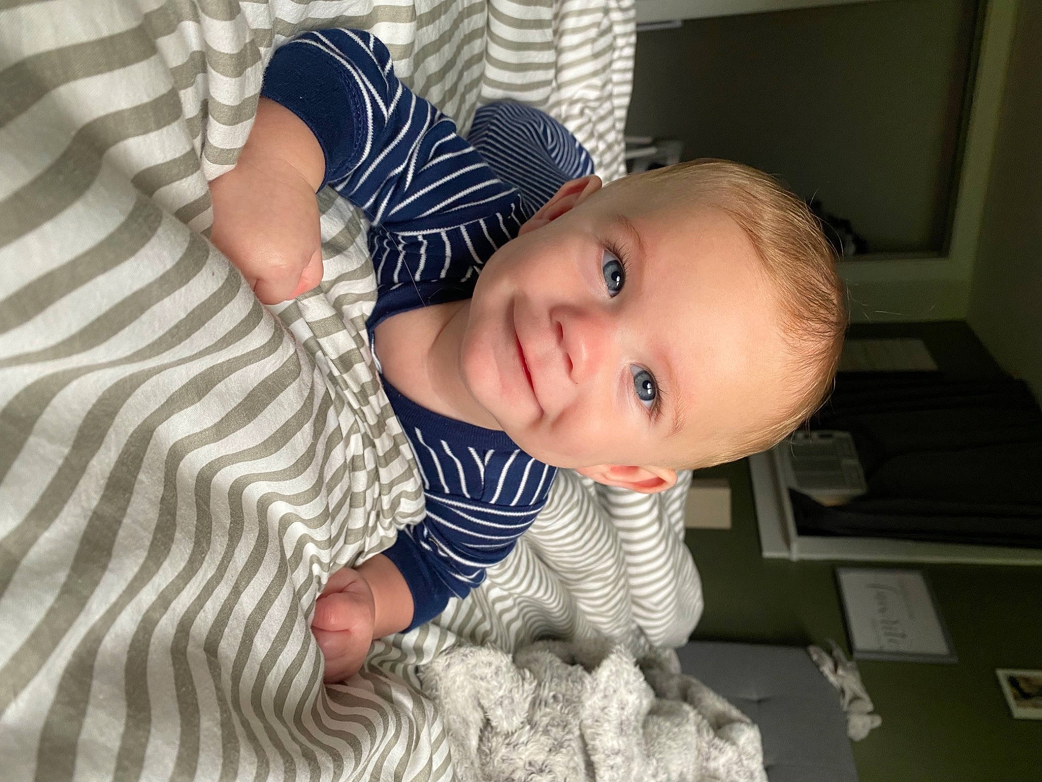 Laine is registered to the contest to win money with this photo: arm, baby, baby_toddler_clothing, cheek, chin, dress, eye, face, flooring, happy, head, human_body, iris, joy, leg, nose, person, skin, sleeve, smile