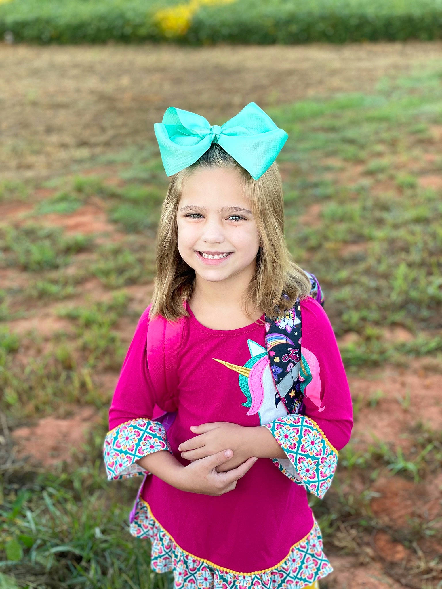 Kinsley joined the competition — help win amazing prizes! cap, clothing, eye, face, grass, green, happy, headgear, iris, joy, leaf, mammal, nature, people_in_nature, person, photograph, pink, plant, sleeve, smile