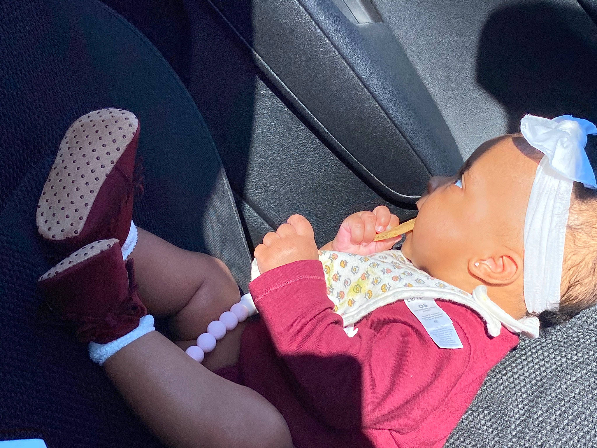 Raelyn is registered to the contest to win money with this photo: arm, automotive_design, baby, baby_toddler_clothing, car_seat, comfort, finger, gesture, hat, human_body, joint, knee, lap, leg, mouth, nail, person, skin, thigh, toddler