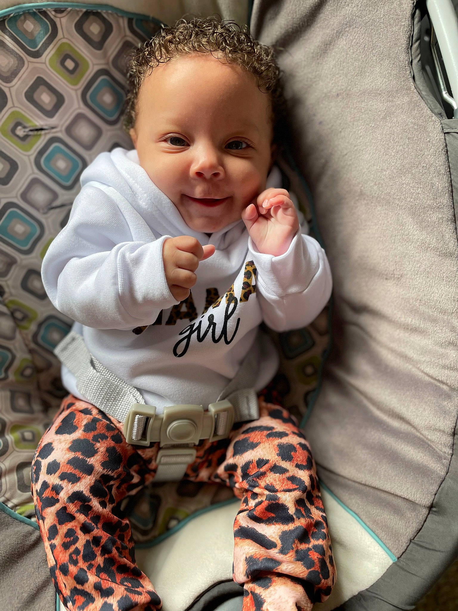 Alayah is registered to the contest to win money with this photo: arm, baby, baby_toddler_clothing, child, comfort, face, finger, hairstyle, hand, happy, head, knee, leg, pattern, person, sitting, sleeve, smile, thigh, toddler