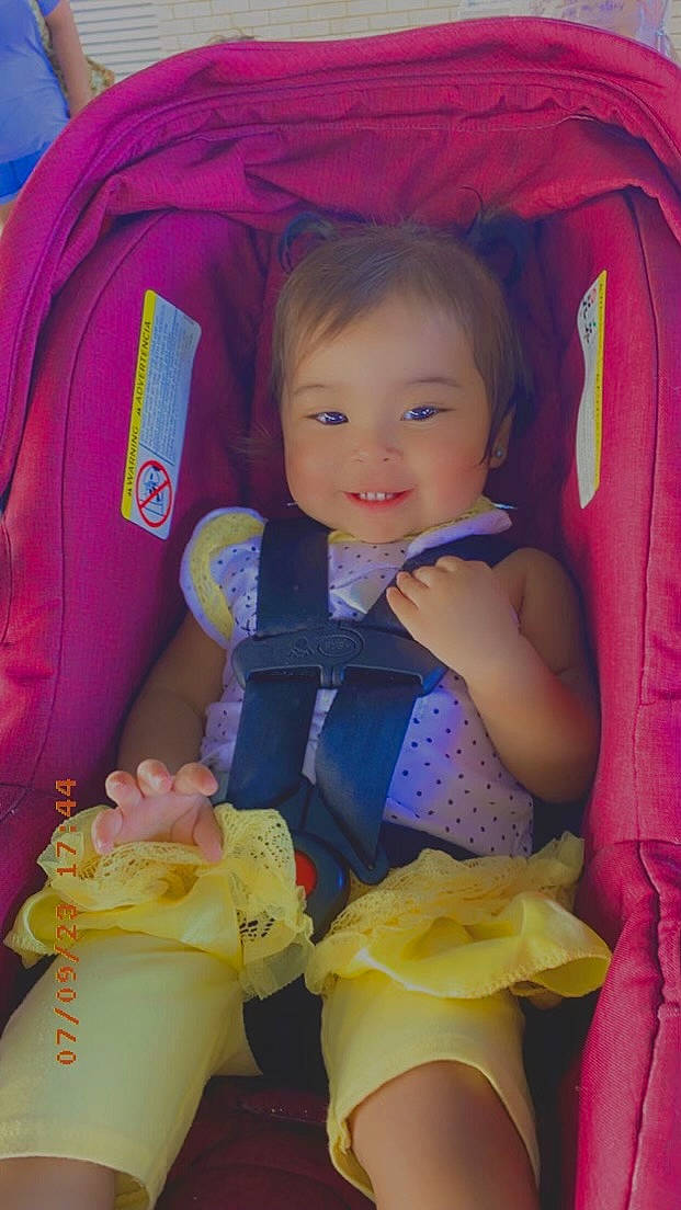 Liberty is registered to the contest to win money with this photo: baby, baby_toddler_clothing, cheek, child, comfort, fun, happy, human_body, iris, mouth, organ, person, pink, purple, skin, sleeve, smile, textile, thigh, toddler