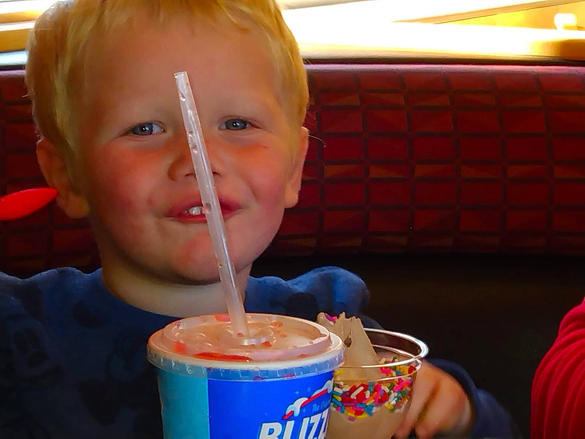 Nicholas is registered to the contest to win money with this photo: baby, child, chocolate_milk, coffee, dairy, dessert, drink, drinking, drinking_straw, drinkware, food, fun, gelato, ice_cream, ingredient, joy, junk_food, non_alcoholic_beverage, person, smile