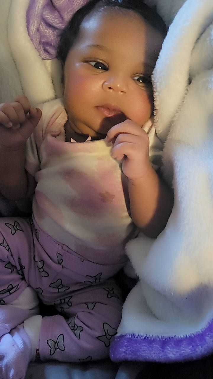 Myla joined the competition — help win amazing prizes! arm, baby_toddler_clothing, black_hair, cheek, eyelash, face, finger, flash_photography, gesture, hand, happy, head, lip, nose, person, skin, smile, textile, thumb, toddler