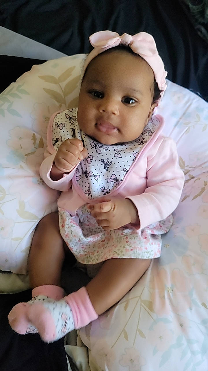 Myla joined the competition — help win amazing prizes! baby, baby_products, baby_toddler_clothing, cheek, child, comfort, fashion_accessory, finger, hand, happy, headgear, linens, pattern, person, pink, sitting, skin, sleeve, smile, toddler