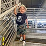 Patrick joined the competition — help win amazing prizes! boy, camo_shorts, casual_clothing, child, concrete, fashion, fedora, handrail, hat, parking_garage, person, portrait, railing, smiling, sneakers, stairs, standing, step, tshirt, urban