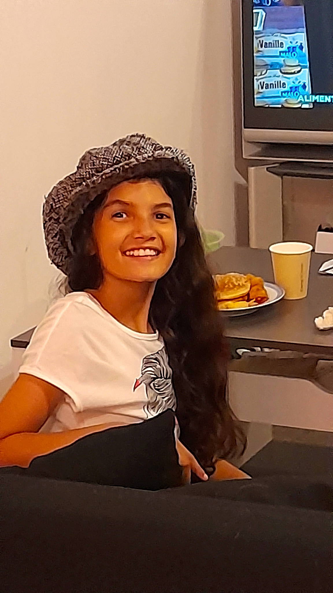 Lola participe au concours pour gagner de l'argent avec cette photo : black_hair, brown_hair, cap, display_device, eyewear, fashion_design, flash_photography, flooring, fun, happy, hat, headgear, headwear, home_appliance, joy, led_backlit_lcd_display, long_hair, person, sleeve, smile