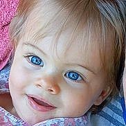 Charlie participe au concours pour gagner de l'argent avec cette photo : toddler, child, smiling, blue_eyes, blond_hair, floral_clothing, face, portrait, close_up, outdoor, towel, grass, happy, skin, eyelashes, baby, person, cute, head, expression