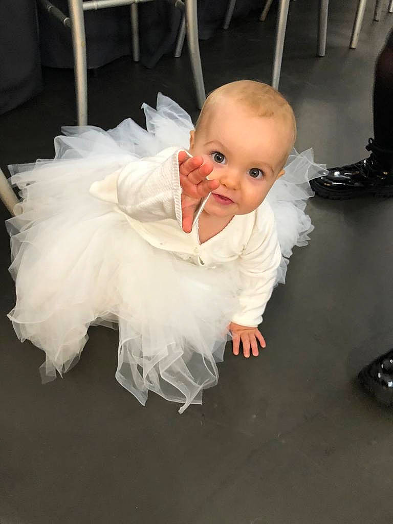 Malvina a rejoint le concours — aidez-le/la à gagner de superbes lots ! baby, baby_products, baby_toddler_clothing, chair, cheek, comfort, dress, embellishment, event, flash_photography, flooring, formal_wear, fun, happy, person, petal, room, sitting, sleeve, smile