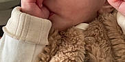 Luna participe au concours pour gagner de l'argent avec cette photo : baby, infant, thumb_sucking, close_up, face, blue_eyes, fur_vest, cozy, cute, child, soft_lighting, portrait, clothing, hand, skin, expression, young, person, indoor, candid
