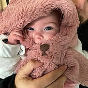 Luna participe au concours pour gagner de l'argent avec cette photo : baby, child, adult, face, hand, costume, pink, fur, cute, portrait, smiling, clothing, cozy, holding, warm, indoor, closeup, person, happy, toddler