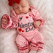 Charlie is registered to the contest to win money with this photo: baby, blanket, closeup, cozy, cute, hand, headband, hearts, infant, newborn, peaceful, pink_onesie, portrait, red_bow, ruffles, sleeping, sleeping_baby, sock, soft_texture, valentine_text