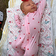 Charlie joined the competition — help win amazing prizes! baby, sleeping, pink_onesie, red_hearts, headband, bow, blanket, floral_pattern, outdoor, grass, peaceful, infant, soft_lighting, cute, child, resting, portrait, toddler, cozy, relaxation