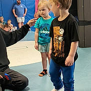 Leilani joined the competition — help win amazing prizes! adult, american_flag, blue, boy, casual_clothing, child, children, flag, floor, gym, indoor, interaction, mat, pants, people, person, shorts, sports, standing, tshirt