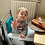 birthday, birthday_candle, cake, celebration, chair, child, face, food, hand, high_chair, indoor, levis, party, radiator, smiling, sweatshirt, table, toddler, waving, young_child