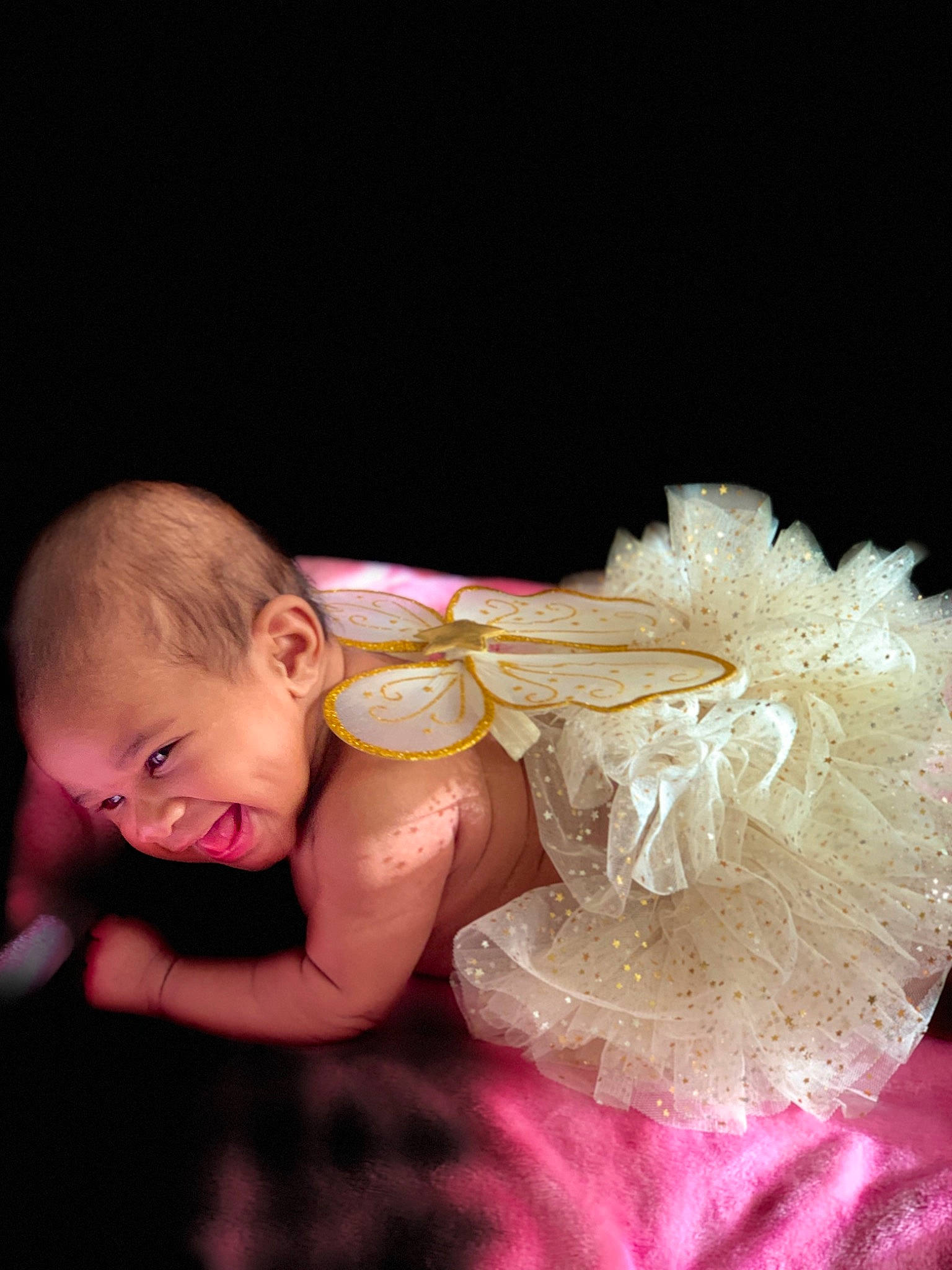 Kharlie is registered to the contest to win money with this photo: abdomen, baby, bridal_accessory, dress, embellishment, flash_photography, fun, gesture, hand, happy, head, headpiece, human_body, iris, nail, people_in_nature, person, petal, pink, toddler