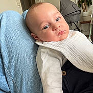 Sahil participe au concours pour gagner de l'argent avec cette photo : baby, infant, bib, denim, clothing, indoor, person, face, legs, stroller, plant, potted_plant, furniture, relaxing, casual, home, seated, portrait, expression, comfort