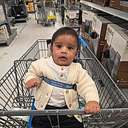Gurnawab joined the competition — help win amazing prizes! baby, shopping_cart, store, aisle, face, child, clothing, cardigan, curious, hand, grip, product_boxes, keurig, retail, indoor, person, infant, grocery, safety_belt, floor