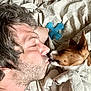 Satchmo participe au concours pour gagner de l'argent avec cette photo : man, dog, bed, blanket, toy, close_up, affection, sleepy, resting, pet, human, animal, nose_to_nose, indoor, cute, friendship, cozy, relaxation, white, brown