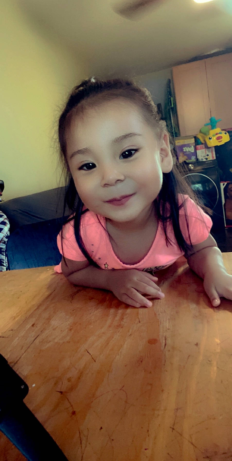 Jasmine is registered to the contest to win money with this photo: cheek, child, eyebrow, face, finger, floor, flooring, forehead, fun, head, joy, mouth, nose, person, skin, smile, thumb, toddler, wood