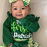 baby, child, smiling, green_clothing, bow, st_patricks_day, holiday, cute, infant, dress, patterned_skirt, shamrock, celebration, portrait, happy, headband, long_sleeves, young_child, cheerful, indoors