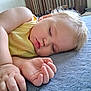 Mara is registered to the contest to win money with this photo: toddler, sleeping, child, yellow_tank_top, bed, blue_blanket, hand, face, crib, wooden_crib, indoor, soft_light, curly_hair, peaceful, young_child, portrait, resting, skin, fingernails, closeup