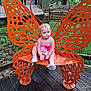 Mara joined the competition — help win amazing prizes! toddler, child, bench, butterfly, orange, outdoor, wood, metal, nature, grass, trees, fence, greenery, cute, shoes, pink_clothing, sitting, portrait, daylight, expression