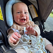 Bode is registered to the contest to win money with this photo: baby, infant, car_seat, blanket, smile, happy, child, clothing, seatbelt, head_support, indoor, closeup, cute, person, toddler, skin, hand, face, expression, comfort