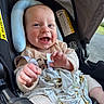 baby, infant, car_seat, blanket, smile, happy, child, clothing, seatbelt, head_support, indoor, closeup, cute, person, toddler, skin, hand, face, expression, comfort