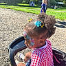 Pheobe is registered to the contest to win money with this photo: adult, child, curly_hair, face_paint, family, floral_design, gingham, girl, grass, hair_bows, outdoor, park, playground, portrait, ride, smiling, summer, sunlight, toddler, wagon