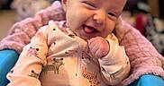 Rowyn joined the competition — help win amazing prizes! animal_print, baby, blue_seat, blurred_background, bookshelf, child, cozy, cute, happy, indoors, infant, onesie, person, pink_blanket, portrait, seated, smiling, soft_lighting, tongue_out, winking