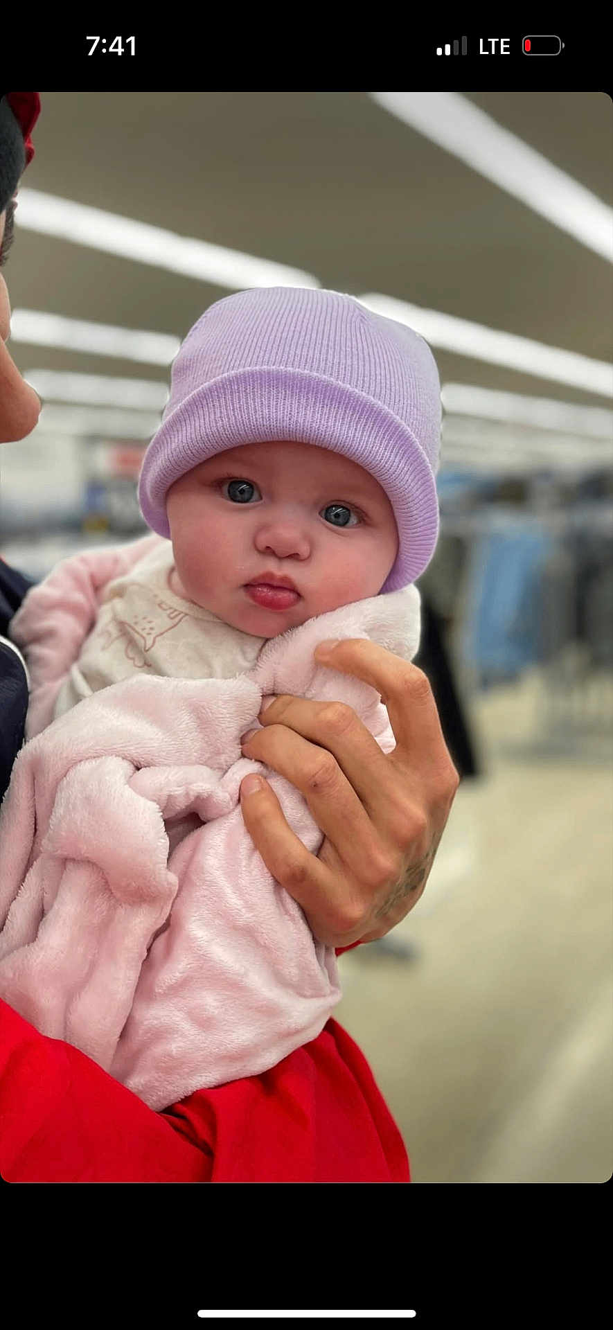 Alyia is registered to the contest to win money with this photo: baby, child, infant, hat, pink_blanket, hand, tattoo, indoor, portrait, cute, face, blue_eyes, clothing, holding, warm, soft_texture, person, newborn, expression, closeup