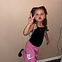 Alyia joined the competition — help win amazing prizes! child, girl, pose, peace_sign, pout, black_tank_top, pink_sweatpants, nike, indoor, wall, floor, hair_tied, playful, young, person, footwear, socks, standing, expression, casual_clothing