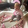 Mason is registered to the contest to win money with this photo: toddler, child, slide, ball_pit, pink_balls, white_balls, curly_hair, indoor_play_area, soft_play_blocks, playroom, smiling, casual_clothing, barefoot, fun, toy, recreation, leisure, kid, happy, activity