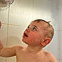toddler, child, wet, bathroom, shower, water, skin, face, curious, blue_eyes, hair, soap_holder, tiles, bath_time, expression, head, shoulder, adult_hand, water_droplets, indoor