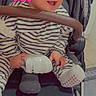 baby, blue_eyes, carseat, child, cute, floor_tiles, grip_bar, hand, holding_shoe, infant, pink_hearts, portrait, seat, smiling, socks, soft_filter, striped_clothing, striped_onesie, stroller, white_shoe