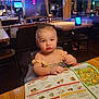 Chevy joined the competition — help win amazing prizes! toddler, child, restaurant, menu, crayon, table, chair, wooden, indoor, lights, food, furniture, person, curious, seated, dress, baby, colorful, family, cozy