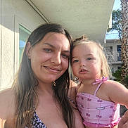 Chevy is registered to the contest to win money with this photo: woman, toddler, child, smile, outdoor, sunlight, selfie, building, palm_tree, clothing, pink, hair, face, arm, summer, nature, portrait, casual, happy, people
