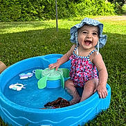Scarlett Rae is registered to the contest to win money with this photo: baby, child, smiling, swimsuit, hat, water, pool, toy, outdoor, grass, summer, play, happy, sitting, nature, sunlight, greenery, cute, fun, water_toy